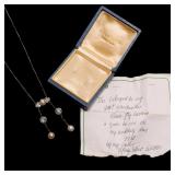 7.2mm pearl flanked by groups of three 0.7ct full cut diamonds, the gallery suspending two chains, e
