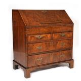 leather writing surface before pigeon holes and fitted stepped drawers, over two half-width drawers 