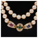 14k yellow gold flower-form clasp mounting melee diamonds, rubies, sapphires, and emeralds, the clas