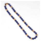 Lot 346  |  LAPIS & 14K GOLD NECKLACE  |  Designed as a single strand of 10mm lapis and gold beads, 