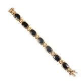 Lot 454  |  JET PLAQUE & 14K GOLD BRACELET  |  Italian, designed as seven oval jet plaques set in 14