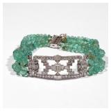 ART DECO DIAMOND & EMERALD TRIPLE STRAND BRACELET | Having an openwork art deco form plaque set with