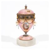 ENAMELED GUILT METAL URN/ORBIT CLOCK | Circa 1920, pink guilloche enamel case with portraits of ange