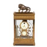 BRASS FERRIS WHEEL GRAVITY CLOCK | 20th century, a ball-bearing gravity clock surmounted by a bronze