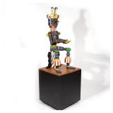 JACQUELINE FOGEL (AMERICAN, 20TH CENTURY) | Polychromed Kachina type seated figure carved in the rou