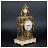 MAISON MARNYHAC ORMOLU MANTEL CLOCK | French, on a marble base with marble urn-form finial, the dial