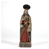 CARVED POLYCHROME SANTOS FIGURE | 19th century or earlier, a robed, haloed, male figure holding a bo