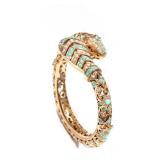 14K SERPENT HARD BRACELET | 14k yellow gold, terminating in serpent head and tail, set with seed pea