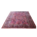 ANTIQUE SAROUK CARPET | Circa 1920s, with an all-over floral vase design on a red ground surrounded 