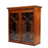 GEORGIAN-STYLE MAHOGANY WALL CABINET | Having overhanging top, over double-glazed doors with through