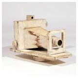 FOLK ART CAMERA BOX TRADE SIGN | Early 20th century, wood, painted white. h. 14 w. 20 d. 12 in.