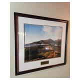 framed art work, coastal landscape of a beach, hills and town