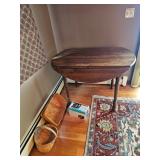 Drop leaf wooden table, Fringed Oriental rug, Wooden baskets