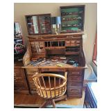 Wooden roll top desk, Wooden wheeled desk chair, Die cast cars in case, desk lamp