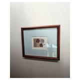 Framed artwork of seashells in shades of brown