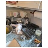 Toaster oven, Tupperware hamburger press, Hand mixer, Plastic measuring cups, Pastry blender, Can op