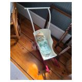 Antique doll baby carriage, Doll in green with blonde hair