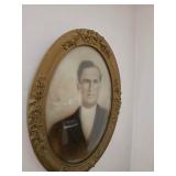 Old style ornate oval frame of a man 