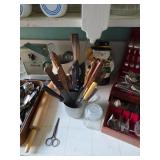 Large selection of knives, rolling pin, silverware in serving case
