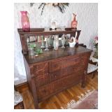 Wooden Tiger Oak sideboard or server with mirror and shelf, Cranberry glass pitcher or vase, Green g