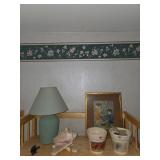 Pots, framed artwork, small green lamp, sea shells
