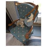 wooden rocking chair with blue padding, stuffed bears, denim purse, blue rope or braided rug
