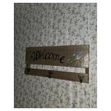 Welcome sign with three hooks