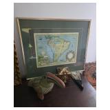 framed wall art appears to be a replica print of a 1630 map of South America