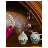 This Irish porcelain set includes a covered sugar bowl and creamer with green shamrock designs and a