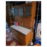 Lunch box, antique Sellers brand Hoosier cabinet features solid oak construction and distinctive gla