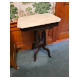 antique Eastlake style parlor table features a white marble top and walnut wood base.