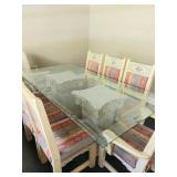 Glass table held up with two wooden columns 