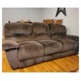 Double recline microfiber sofa with media center middle section.