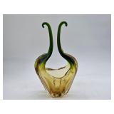  Vintage Murano style art glass basket with an amber body and twin green pulled handle forms in a mid century modern studio style, dating to the 60s.