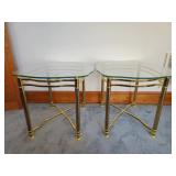 Hollywood Regency style glass top side tables with gold tone metal frames, measuring 24 inches wide 