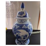 Japanese cobalt blue ginger jars with lids in a chinoiserie style, featuring colorful floral decorat
