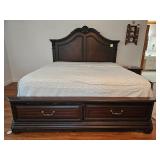 Dark wood bed frame with carved headboard and footboard featuring two drawers; measures 89" x 80" x 