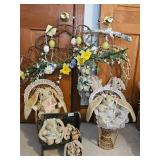 Group of decorative Easter-themed wreaths and plush rabbits with wicker chairs. See pictures for det