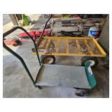 2 metal utility carts with platform and four wheels; largest measures 24" x 48"