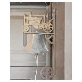 Cast iron wall-mounted bell with tractor motif