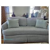 Light sea green upholstered sofa with rounded arms, loose back cushions, single bench seat cushion, 