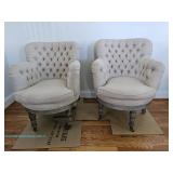 Two upholstered armchairs with tufted backs and wooden legs on casters; measures 24" x 34" x 31"