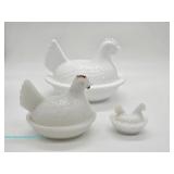 White milk glass hen-on-nest covered dishes with molded feather details, scalloped nest bases, and r