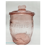 Pink Depression glass covered peanuts jar with embossed PEANUTS lettering, raised peanut motif, ribb