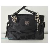 Coach black fabric handbag with silver-tone hardware and interior zip pocket 