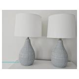 Two ceramic table lamps with textured bases and white shades, in working condition; measures 24" 1"/