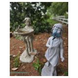 Two plastic garden statues of children, one holding a birdbath and the other with a pinwheel. 41" T 