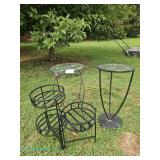 Metal plant stands with glass tops and one folding three tier plant stands.