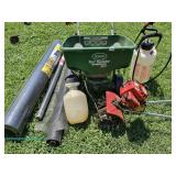 Scotts Turf Builder EdgeGuard DLX broadcast spreader with assorted gardening tools and materials