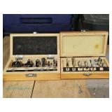 Two sets of router bits in wooden cases labeled Craftsman and Mastergrip